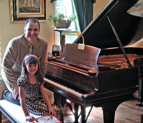 Professor Jelasic with one of his young students following her piano recital